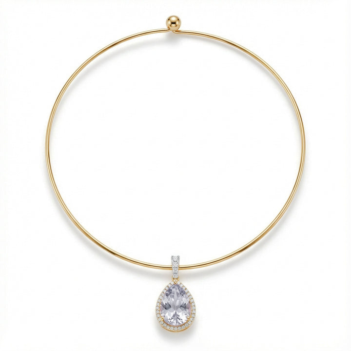 Gold necklace with a teardrop-shaped diamond pendant on a white background