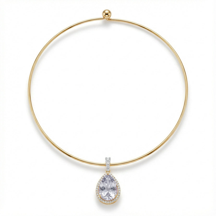 Gold necklace with a teardrop-shaped diamond pendant on a white background